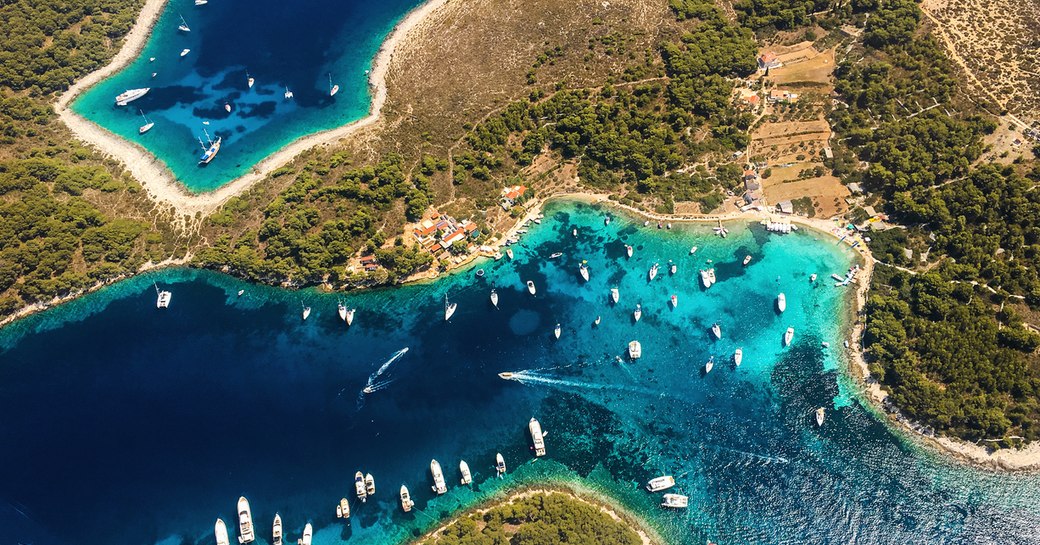 islands of croatia, aerial view with bright blue water and yachts