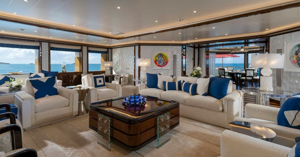Overview of the main salon with plush white seating onboard charter yacht ALFA NERO