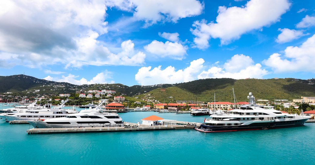 Overview of Yacht Haven Grande in St Thomas US Virgin Islands, superyachts moored at berths with Charlotte Amalie in background