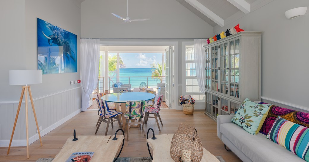 entertainment room on villas of thanda island, with balcony overlooking the sea and sofa in foreground