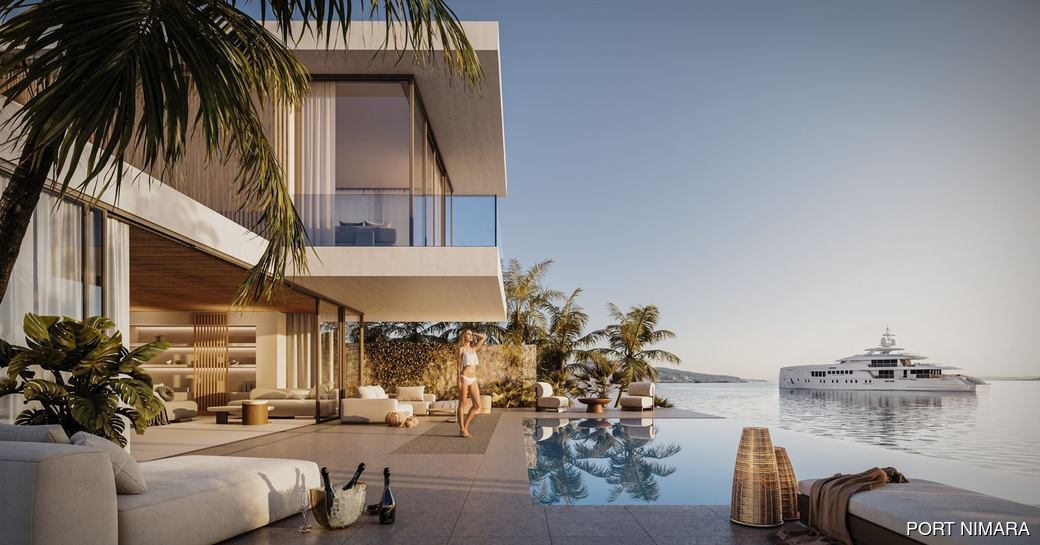 Waterfront impression of guest at Port Nimara with charter yacht at anchor