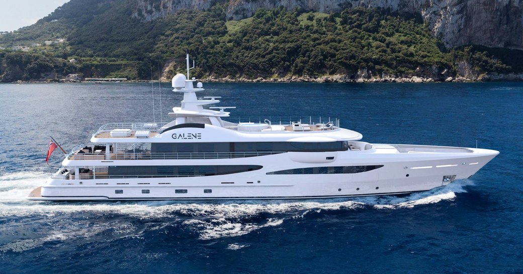 Charter yacht GALENE underway with cliffs in the background