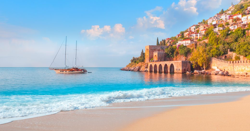 Turkish coastline with a gulet yacht at anchor