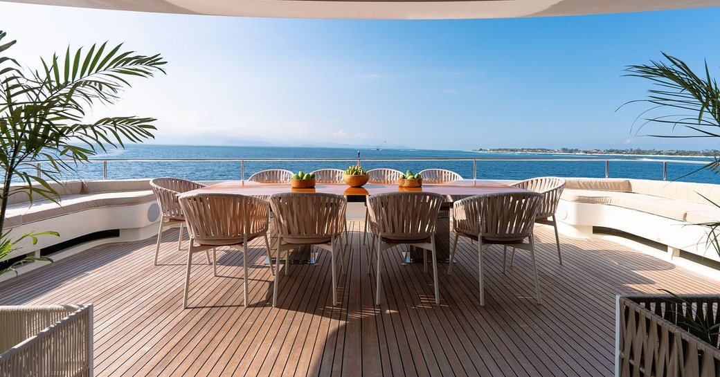 Aft deck onboard luxury yacht charter GALILEO with alfresco dining table and chairs