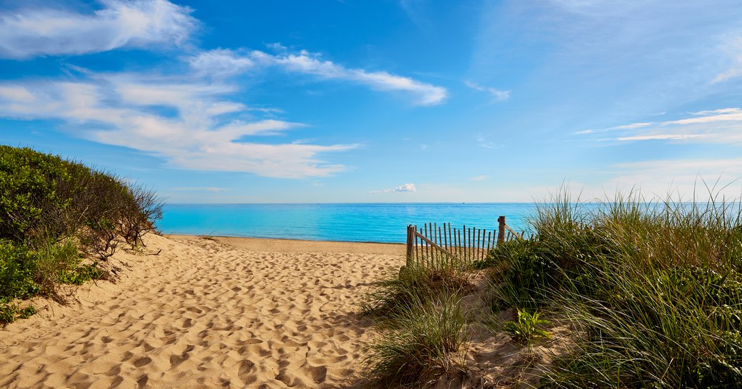 Sandy beach in New England, with blue sea in background 