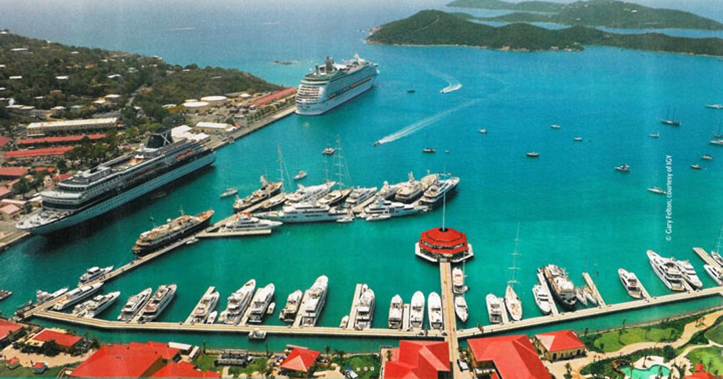 An aerial shot of superyachts berthed in a Caribbean marina