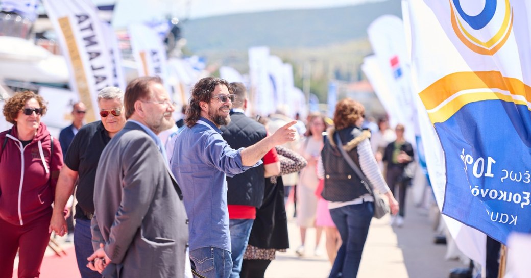 Visitors at the Mediterranean Yacht Show (MEDYS) on the red carpet discussing surrounding yacht charters