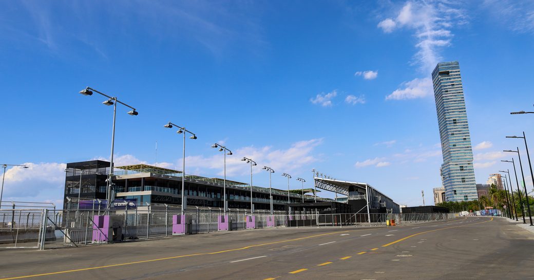 Ground level view of Jeddah Corniche Circuit, stands to left with tower in background.