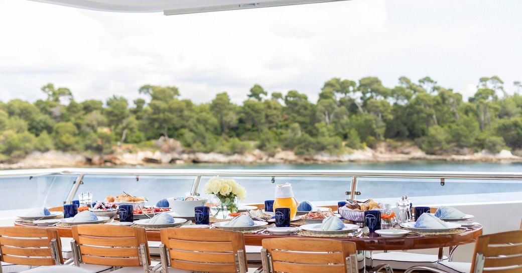 dining set up overlooking mediterranean island 