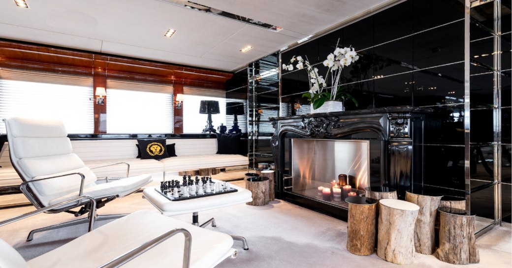 white sofa and armchairs form seating area in motor yacht BLISS 