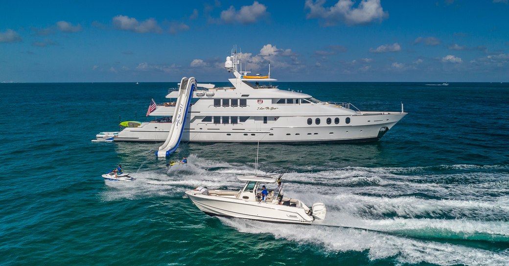 Charter yacht I LOVE THIS BOAT at anchor with waterslide and tender