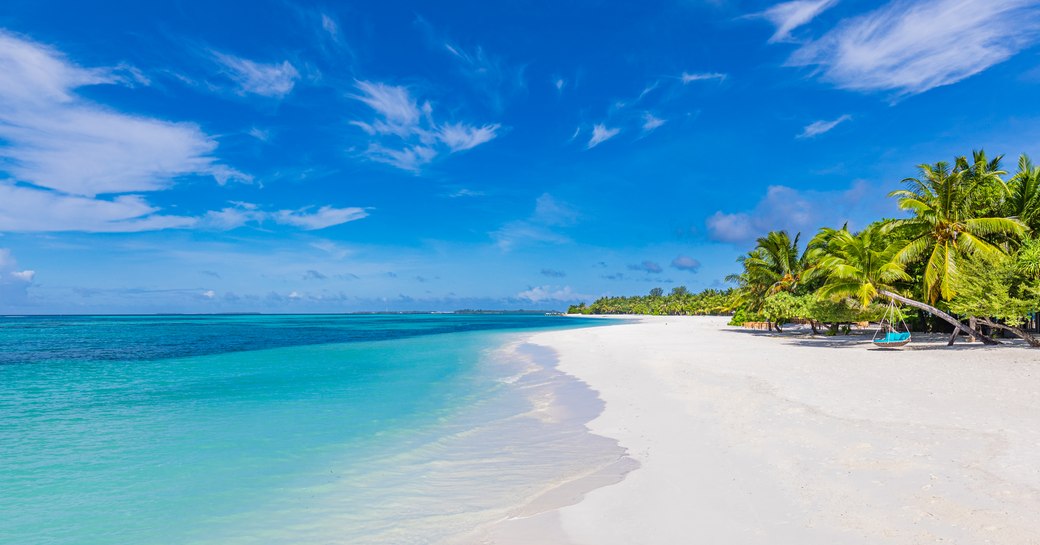 Blue water and white sandy beach in the Caribbean