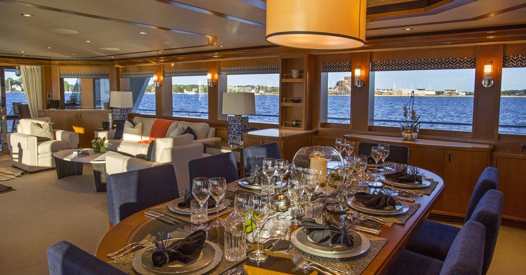 Main salon on luxury yacht Far Niente, with large windows and formal dining 