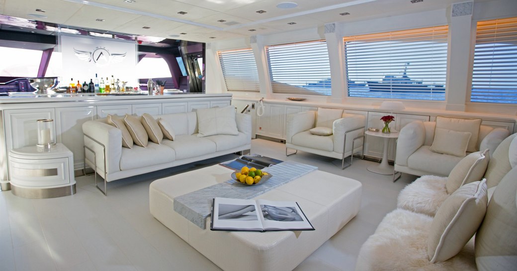 The cream furnishings which make up the main salon of superyacht ASCARI
