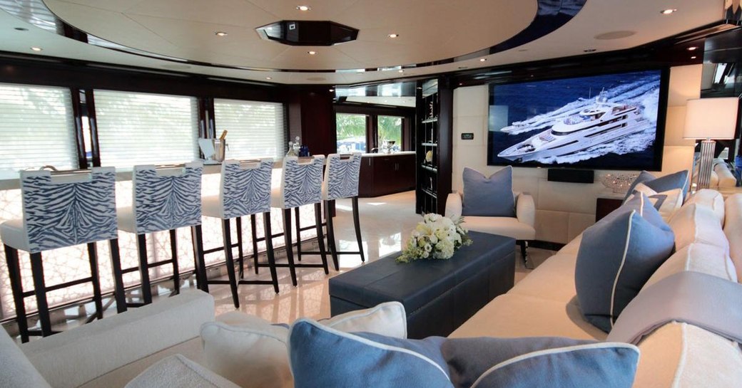 stools line the granite-topped bar with a sofa nearby on board superyacht TRENDING 