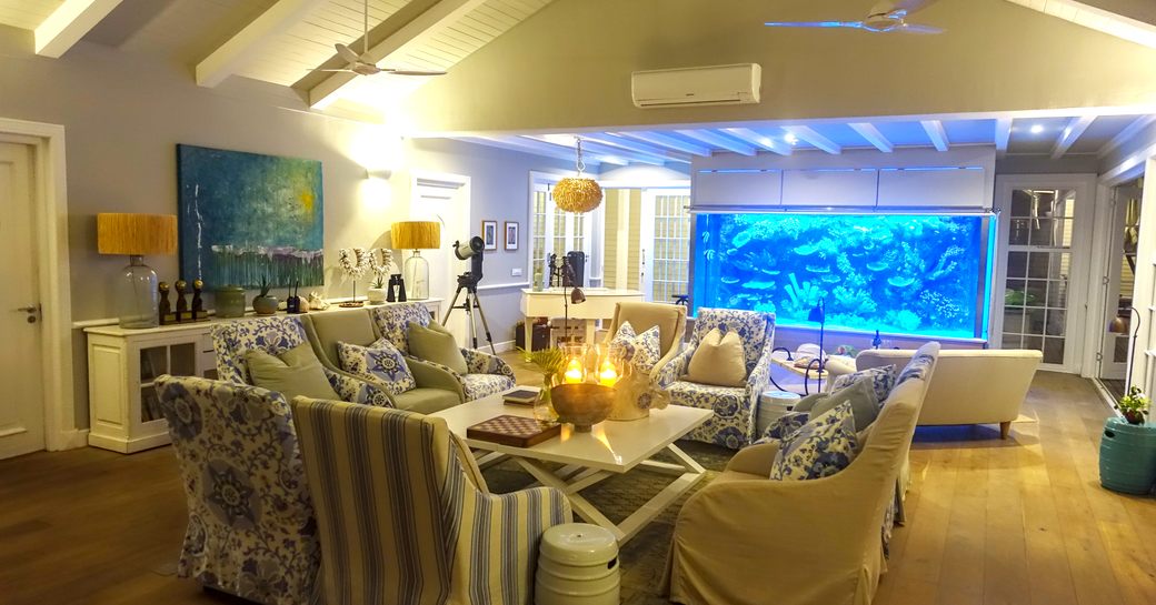 family room on thanda island, with lounge seating and aquarium