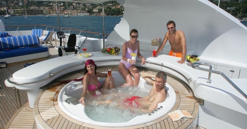 Charter guests sit in jacuzzi pool of superyacht Lady Ellen II as she charters in Greece