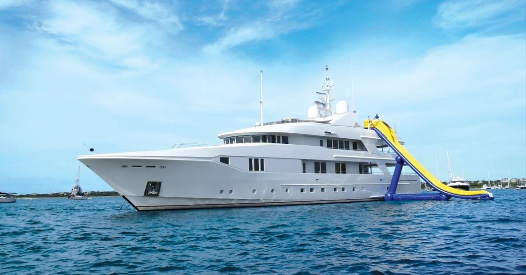 Luxury yacht RHINO sat at-anchor with her inflatable slide attached