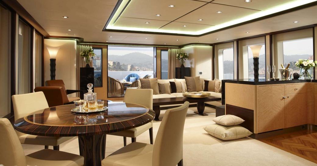 games table and seating area in the Asian-inspired main salon on board motor yacht GLADIATOR 