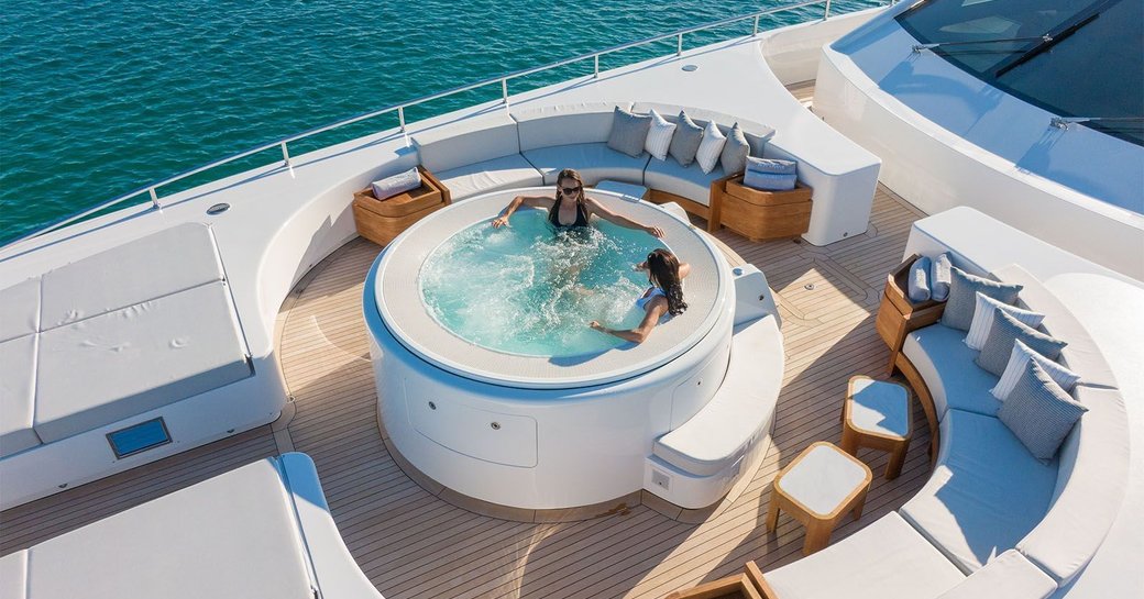 two beautiful ladies sat in hot tub on luxury charter yacht in the Caribbean