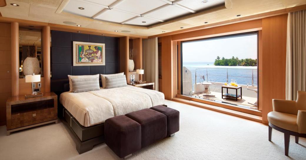 Cabin with double bed and gladd patio doors looking out to sea on Superyacht SUNRAYS