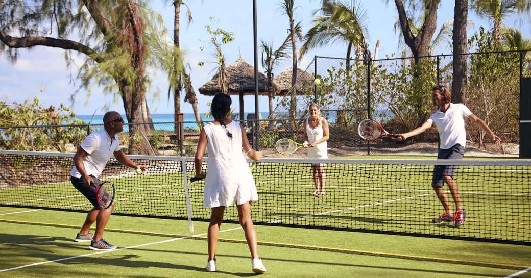 people play tennis on sports court on thanda island