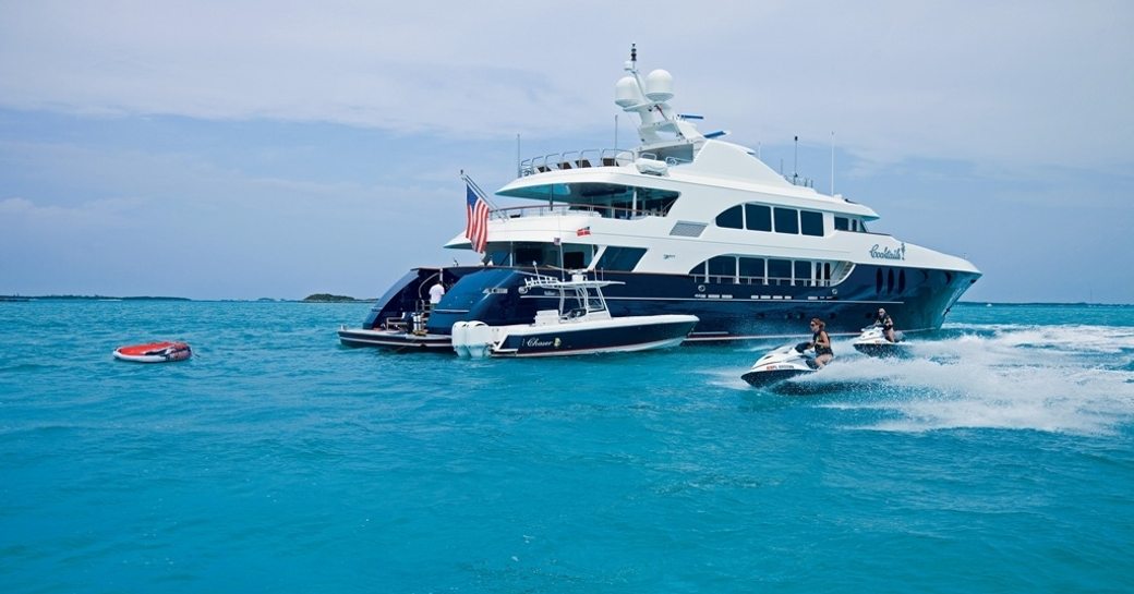 motor yacht COCKTAILS anchors on charter in the Caribbean alongside water toys
