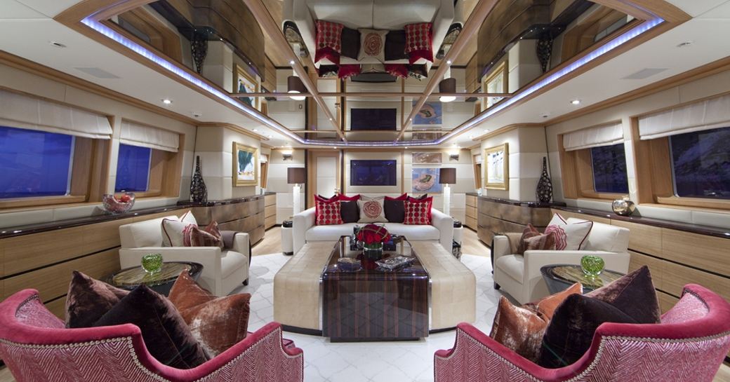 main salon with sofas and armchairs facing coffee table on board motor yacht ‘Big Change II’ 