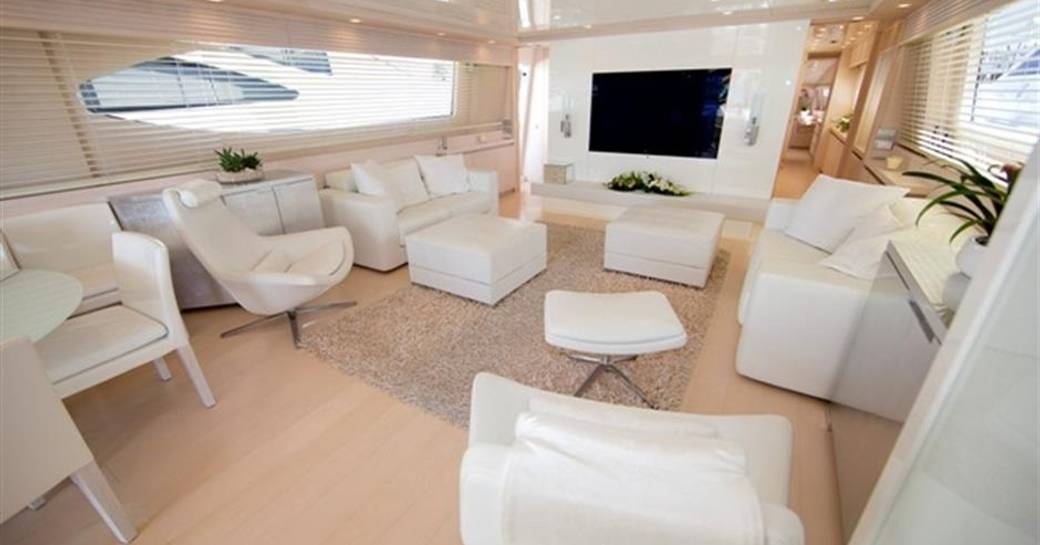 white sofas and armchair in main salon of charter yacht Tuscan Sun