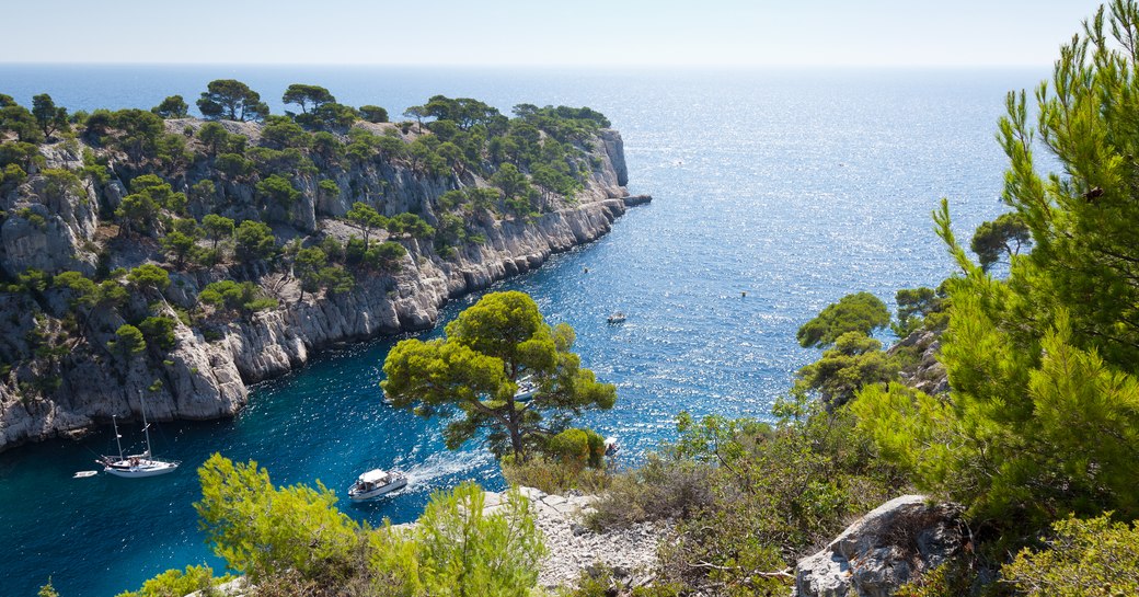 Mediterranean landscape and sparkling sea with charter yachts on the water