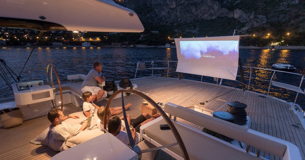 aft deck of sailing yacht gliss, with open air cinema set up for charter guests