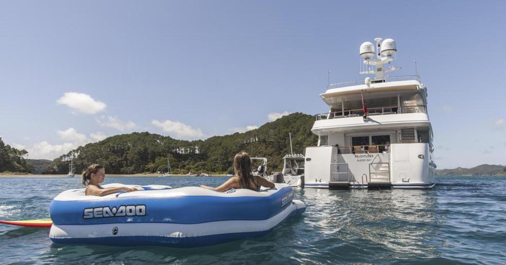 Charter guests relax in a Seadog whilst gazing upon M/Y RELENTLESS