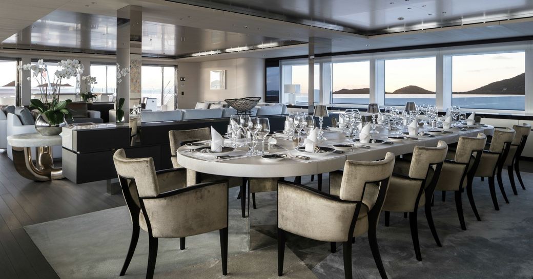 large dining table forward of a seating area in the main salon aboard superyacht NAUTILUS