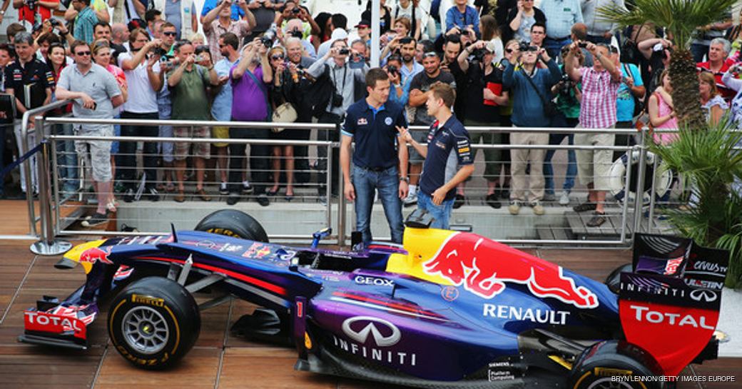 Sebastian Vettel and Infiniti Red Bull Racing shows French rally driver Sebastien Ogier around the Red Bull Energy Station and showcar during the Monaco  Grand Prix on May 22, 2013 in Monte-Carlo