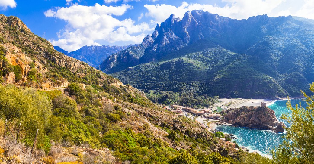 sun shining on rugged mountains in Corsica, France