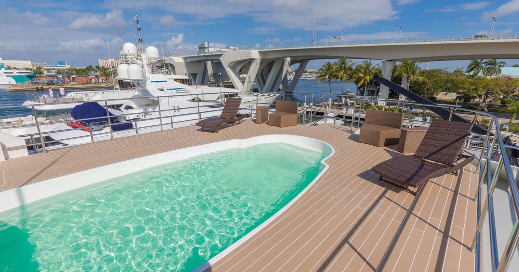 Large pool on sundeck of luxury expedition yacht GLOBAL, with views overlooking the ocean