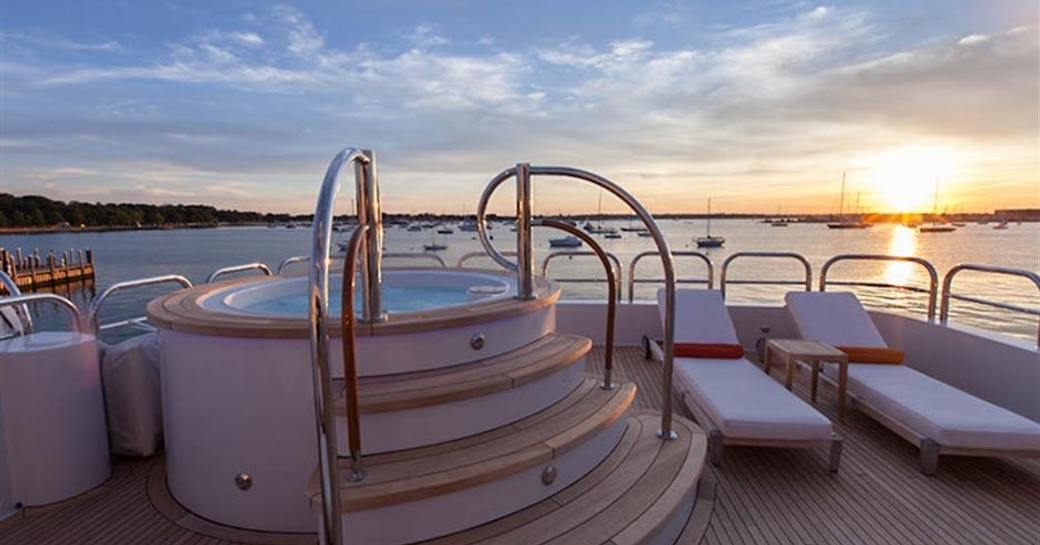 Jacuzzi on board sun deck of charter yacht Aspen Alternative with sunset in background