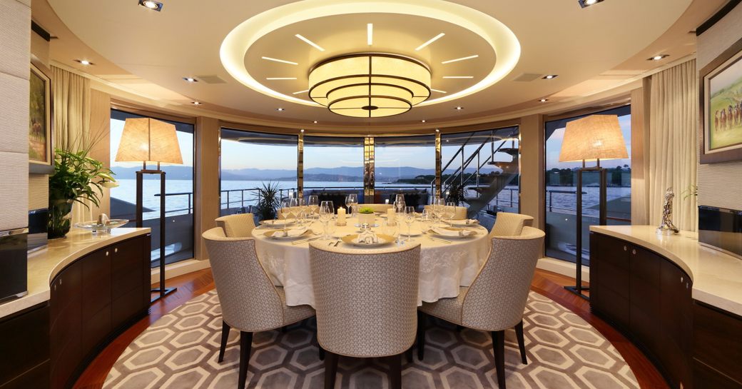 circular dining table in the main salon of superyacht AURELIA