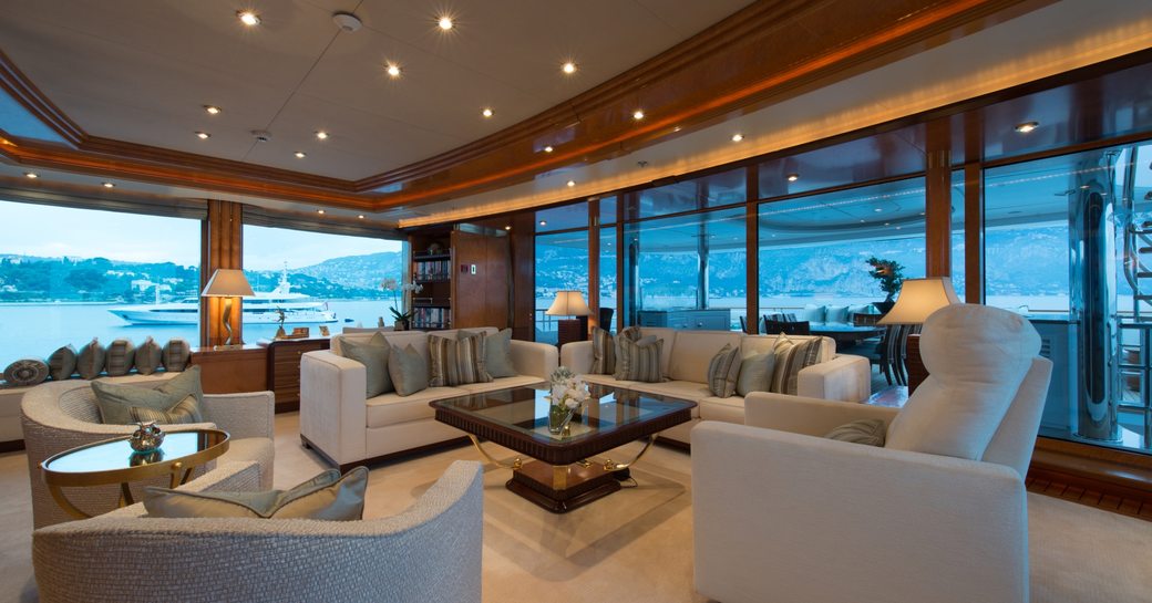 Overview of the main salon onboard motor yacht LADY MAJA I, spacious lounge area surrounded by full height windows 