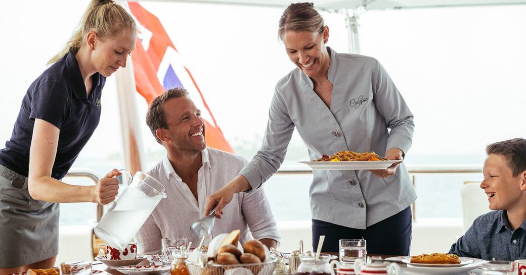 a man is served breakfast on board a luxury superyacht 