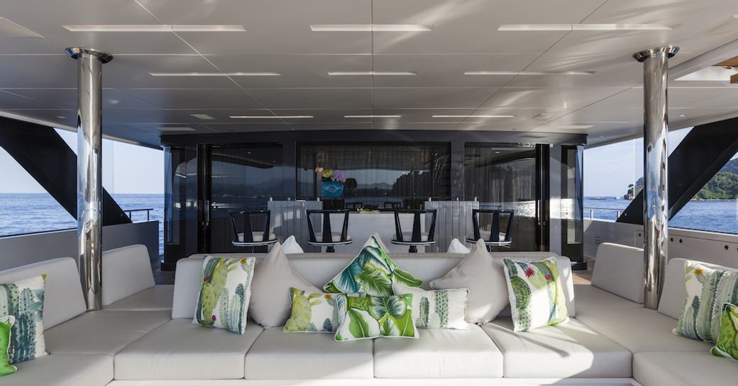 leather seating area on the main deck aft of motor yacht Quinta Essentia