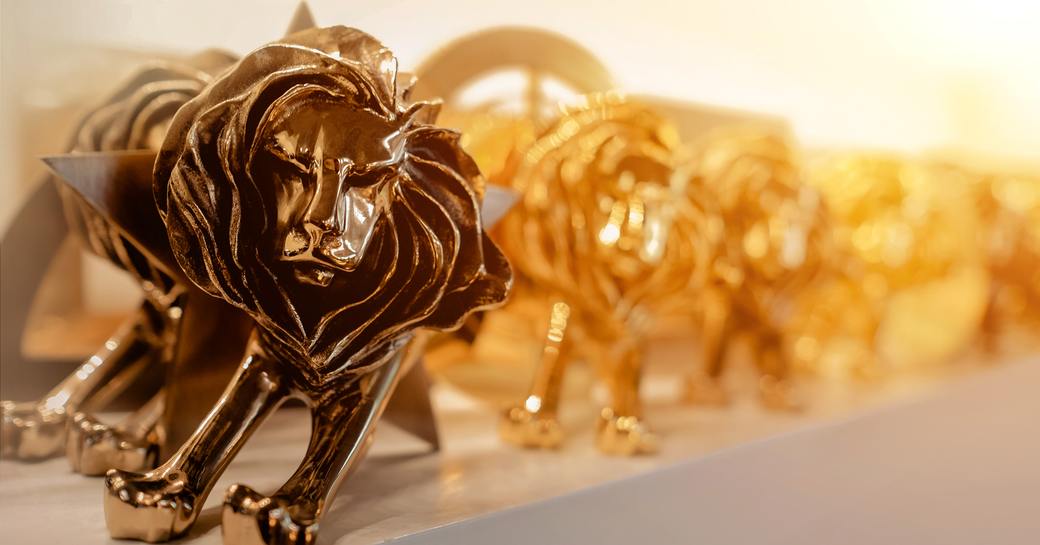Cannes Lions trophies lined up against white background.