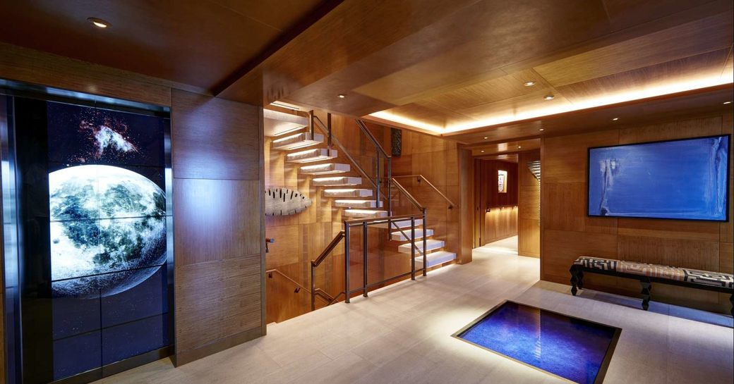 The staircase and video wall inside luxury yacht SYMPHONY
