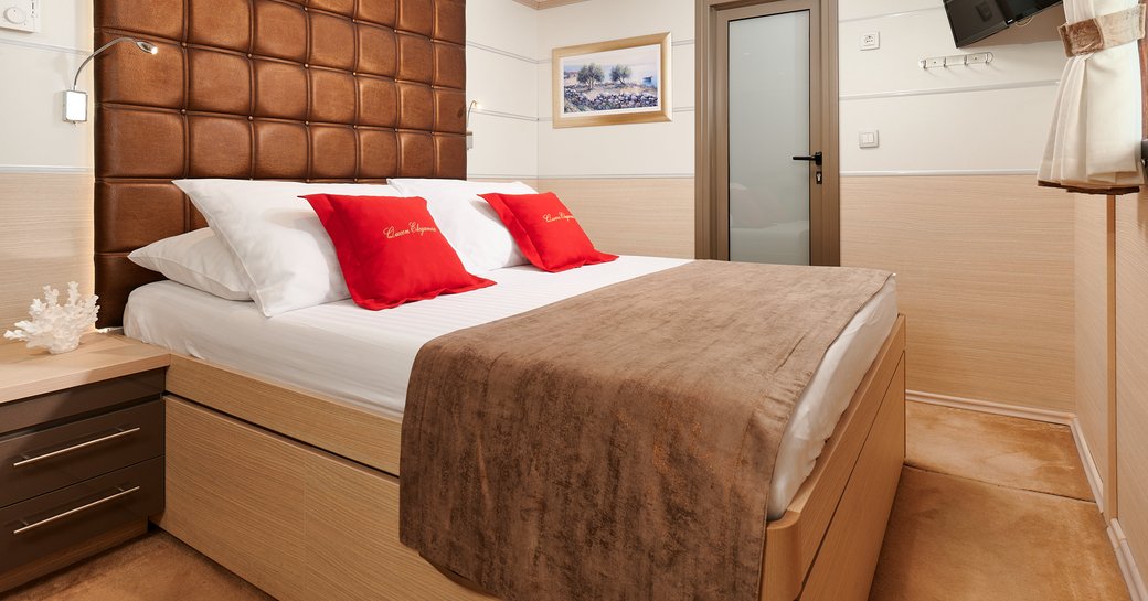 Guest cabin with central berth onboard private yacht charter QUEEN ELEGANZA