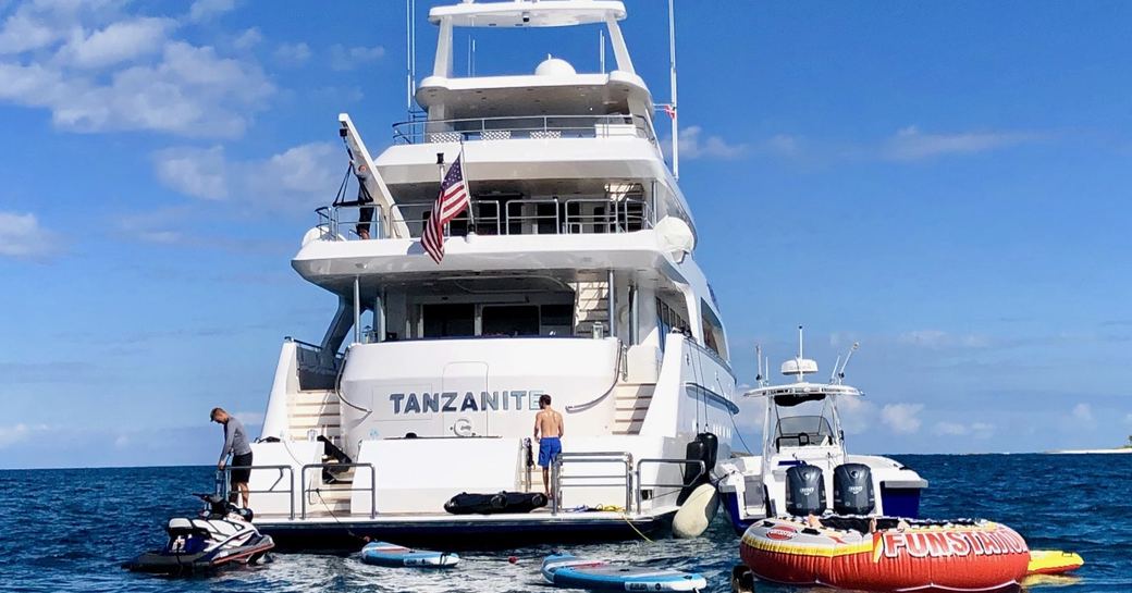 charter guests on the swim platform of luxury yacht TANZANITE surrounded by water toys