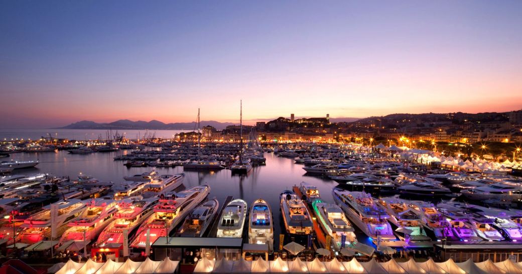 Yachts lit up at night in Cannes harbor