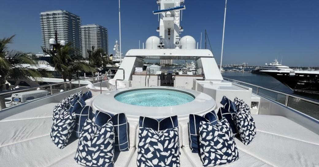 Overview of the deck Jacuzzi onboard charter yacht SPORT, with surrounding sun pads