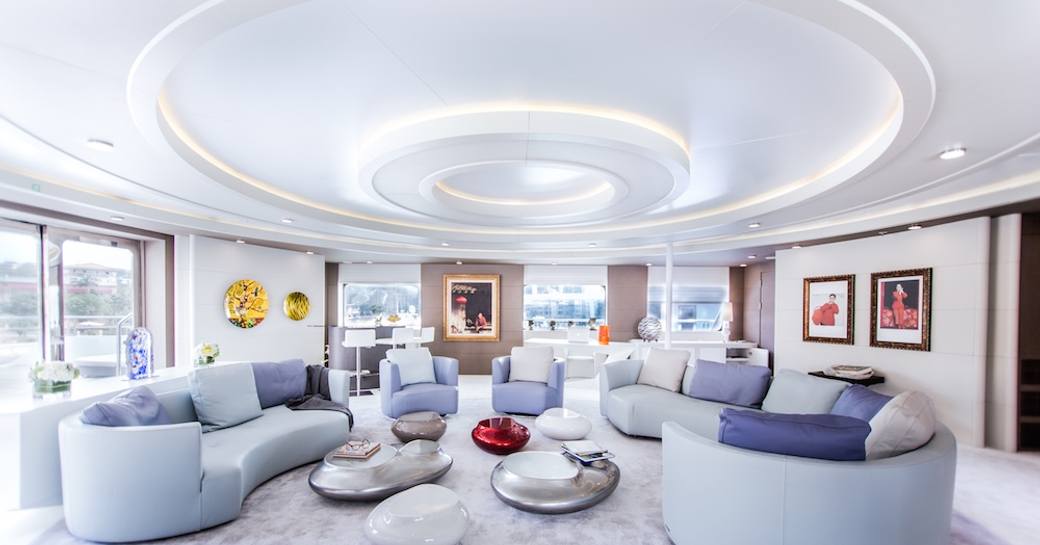 The bright white furnishings and surroundings of a superyacht main salon