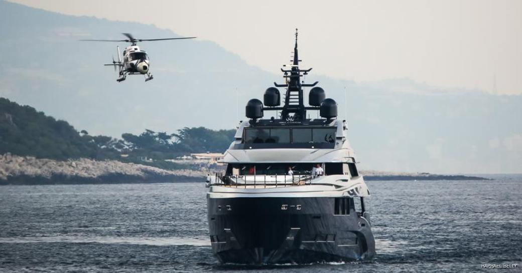 Helicopter flying next to luxury charter yacht used in films