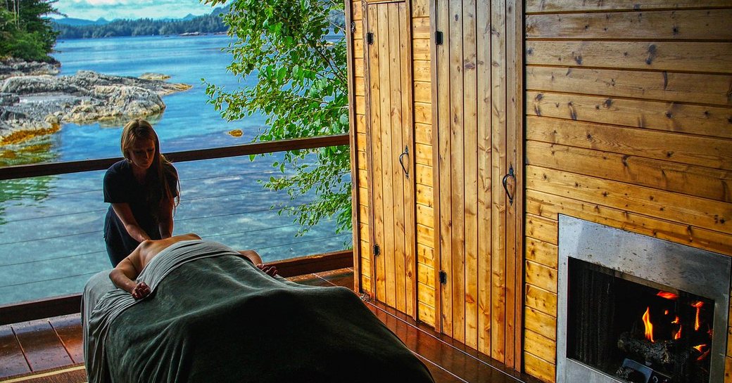 Women massaging in outdoor lodge in Alaska Talon lodge and spa hotel